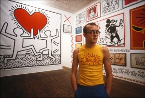 Keith Haring with his work before his solo exhibition opens at Tony Shafrazi Gallery in SoHo.